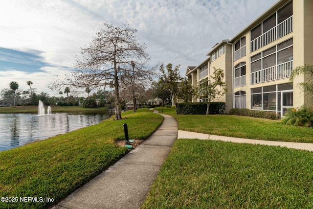 view of property's community featuring a water view and a lawn