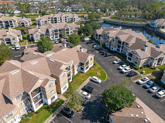 aerial view featuring a residential view and a water view