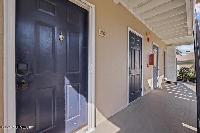 property entrance featuring stucco siding