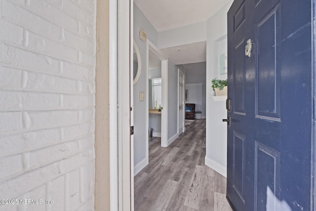 foyer with wood finished floors and baseboards