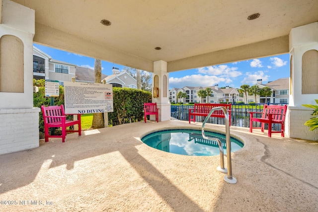 view of pool with a residential view and fence