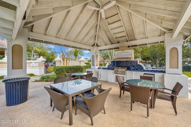 view of patio with area for grilling, a grill, fence, outdoor dining area, and a gazebo