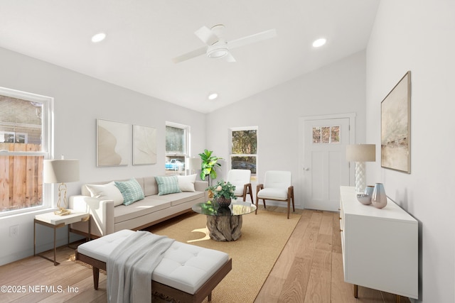 living room featuring lofted ceiling, ceiling fan, light wood finished floors, and recessed lighting