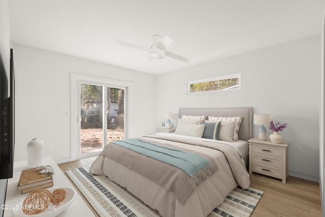 bedroom featuring light wood finished floors, multiple windows, and access to exterior