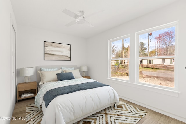 bedroom with wood finished floors and a ceiling fan