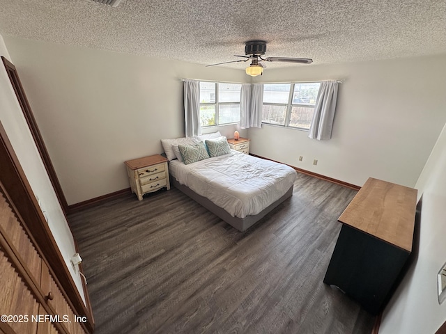 bedroom with ceiling fan, a textured ceiling, and dark hardwood / wood-style flooring