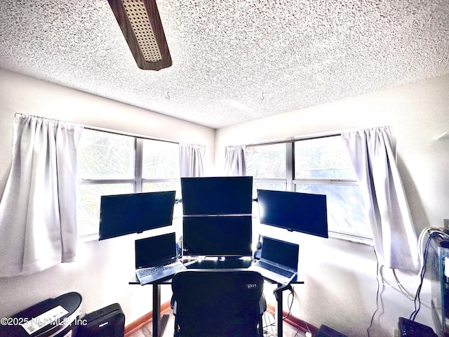 office area with plenty of natural light and a textured ceiling