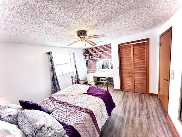 bedroom with ceiling fan, a textured ceiling, a closet, and light hardwood / wood-style flooring