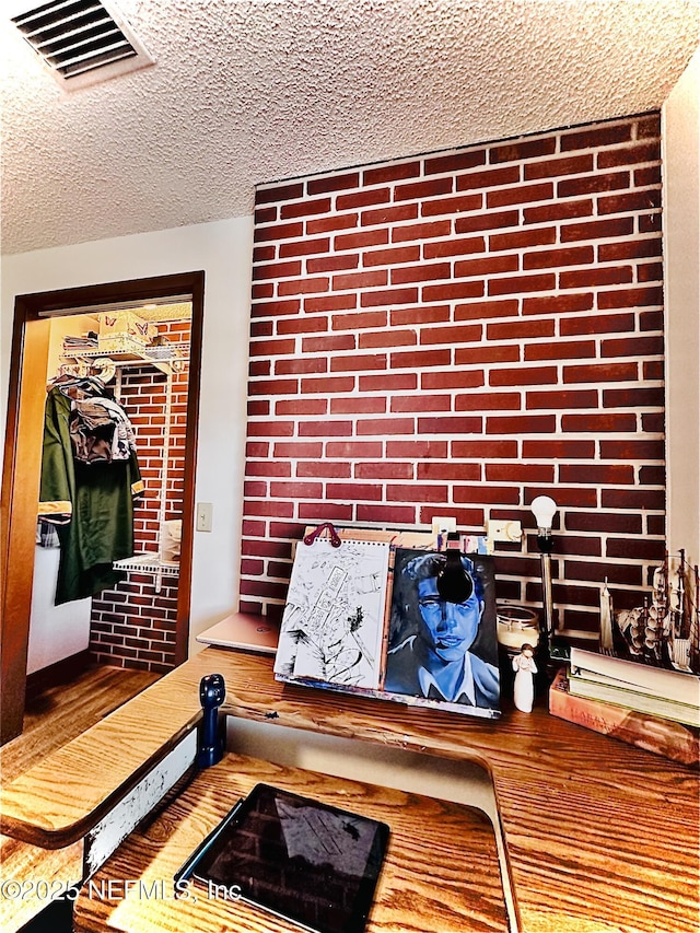 mudroom featuring a textured ceiling