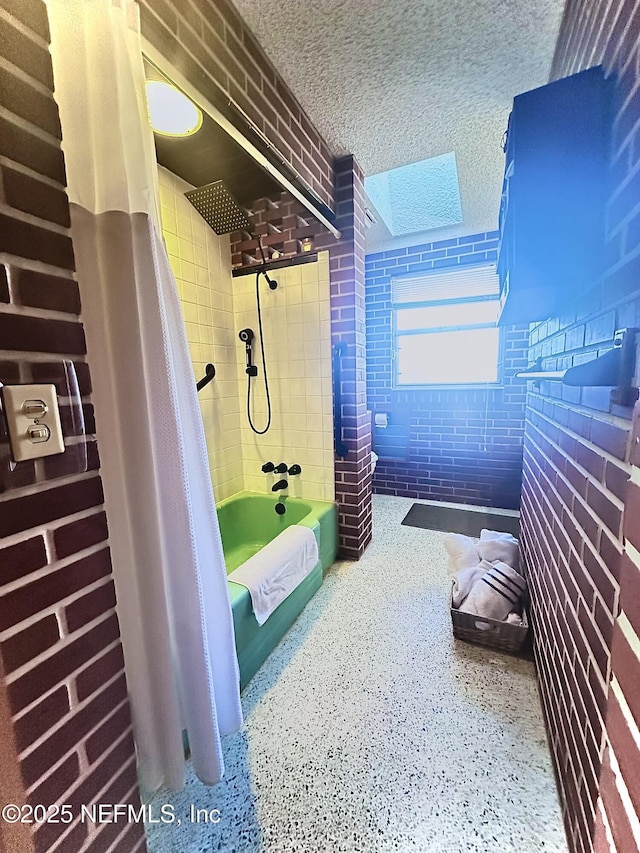 bathroom featuring a textured ceiling and shower / bath combo with shower curtain