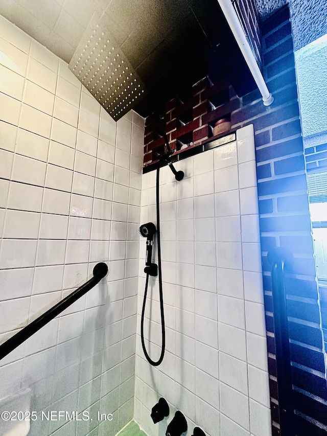 bathroom with tiled shower