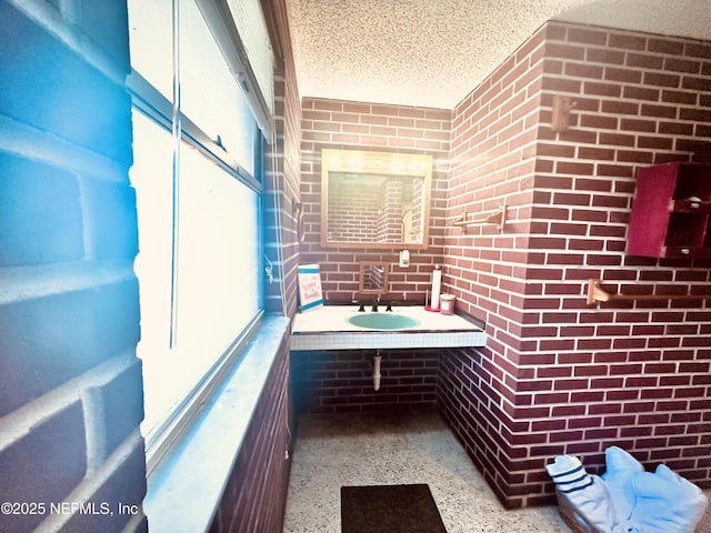 bathroom featuring sink and a textured ceiling