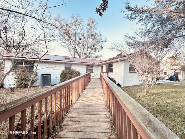 back of property featuring cooling unit and a lawn