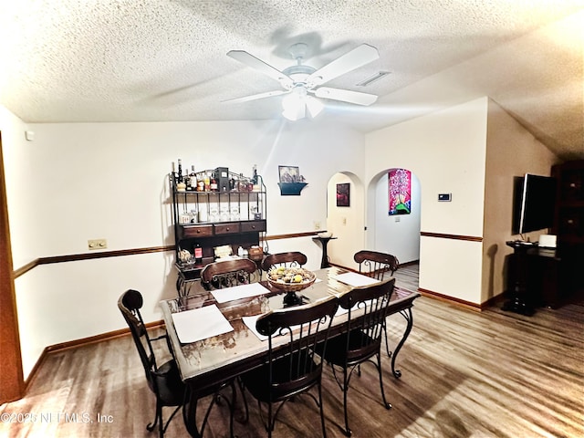 dining space featuring ceiling fan, hardwood / wood-style floors, and a textured ceiling