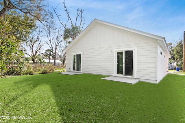 back of property featuring a lawn