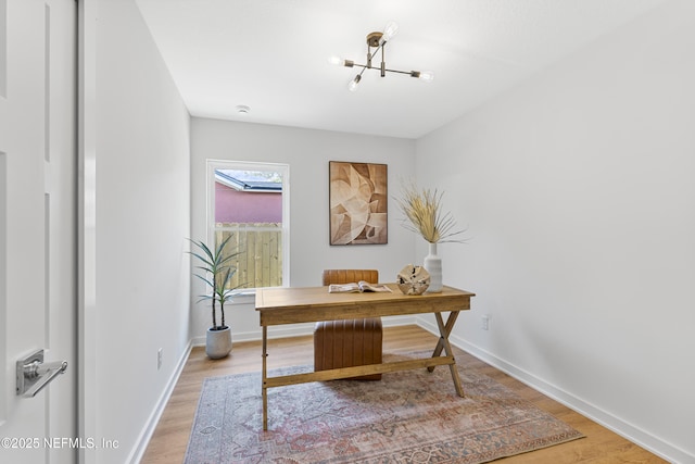 420 Herbert St, Saint Augustine, FL 32084 - office with light wood finished floors, baseboards, and a chandelier