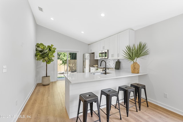 420 Herbert St, Saint Augustine, FL 32084 - kitchen with appliances with stainless steel finishes, a sink, a breakfast bar, and light countertops
