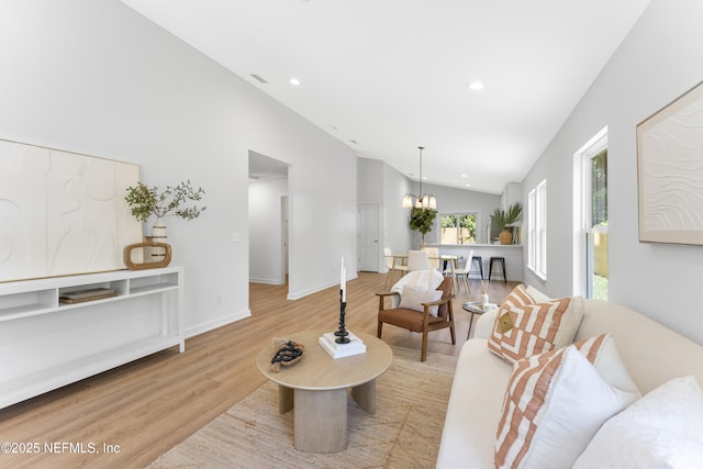 420 Herbert St, Saint Augustine, FL 32084 - living area with recessed lighting, wood finished floors, baseboards, high vaulted ceiling, and a notable chandelier