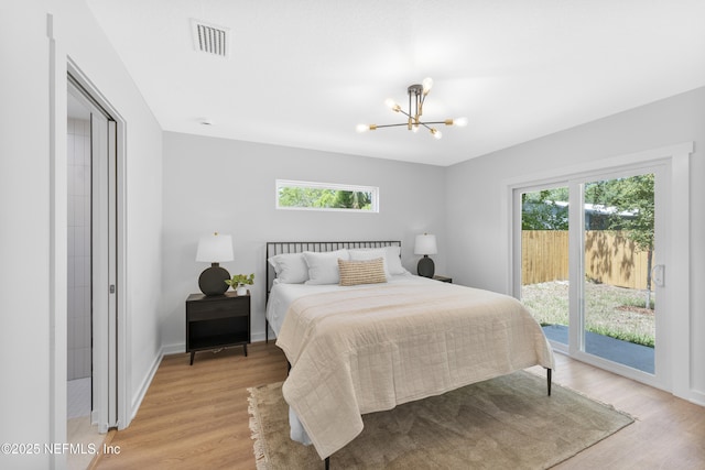 420 Herbert St, Saint Augustine, FL 32084 - bedroom featuring a notable chandelier, light wood-type flooring, visible vents, and access to outside