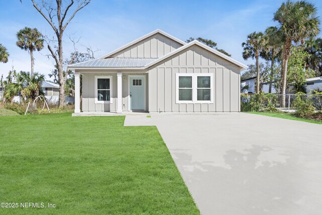 420 Herbert St, Saint Augustine, FL 32084 - modern farmhouse style home featuring board and batten siding, a front lawn, driveway, and fence