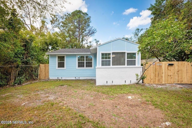 view of side of home featuring a yard