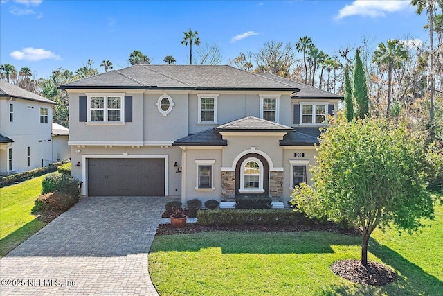 view of front facade with a garage and a front lawn