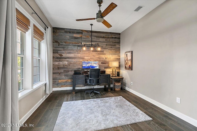 office area featuring ceiling fan, wooden walls, dark hardwood / wood-style flooring, and a wealth of natural light