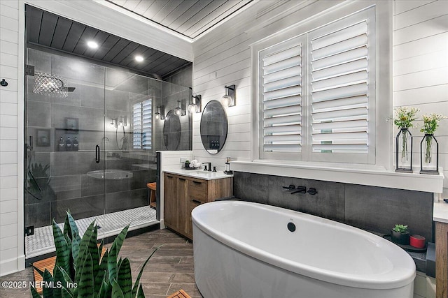 bathroom featuring vanity, wood-type flooring, and shower with separate bathtub