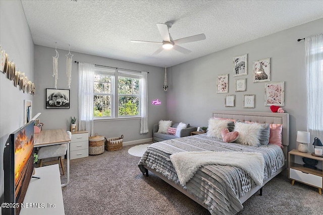 carpeted bedroom featuring ceiling fan and a textured ceiling