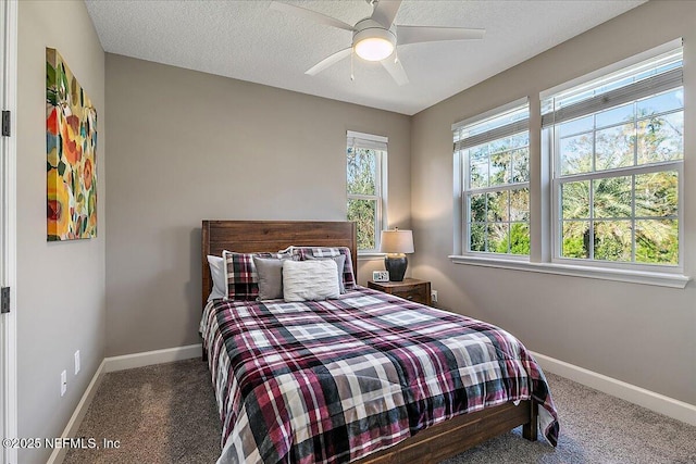 bedroom featuring ceiling fan, carpet floors, and a textured ceiling