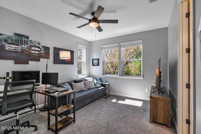 home office with ceiling fan, a textured ceiling, and carpet flooring