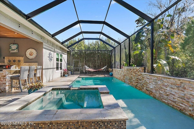 view of pool with a bar, a lanai, a patio, and an in ground hot tub