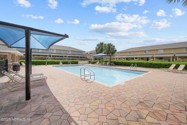 pool featuring a patio area and fence