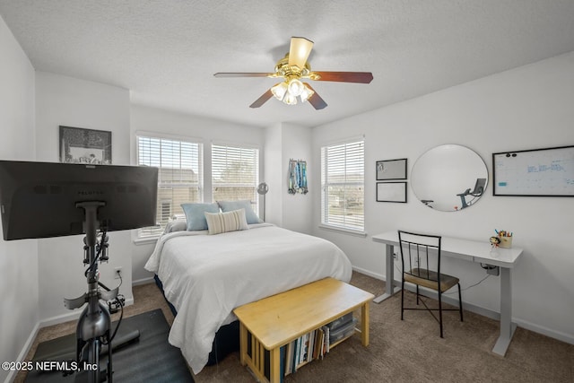 carpeted bedroom featuring ceiling fan, a textured ceiling, and baseboards