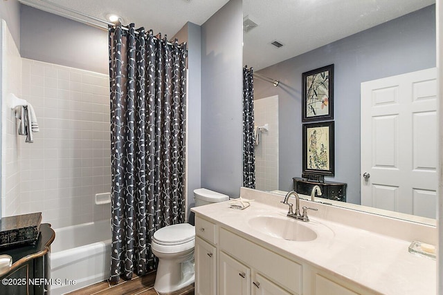 full bathroom featuring shower / tub combo with curtain, hardwood / wood-style floors, vanity, and toilet