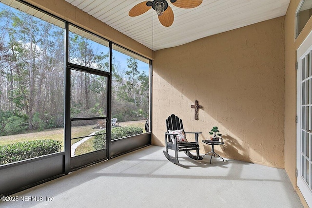 sunroom featuring ceiling fan and a healthy amount of sunlight