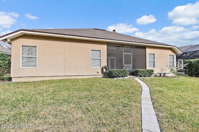 rear view of property with a lawn