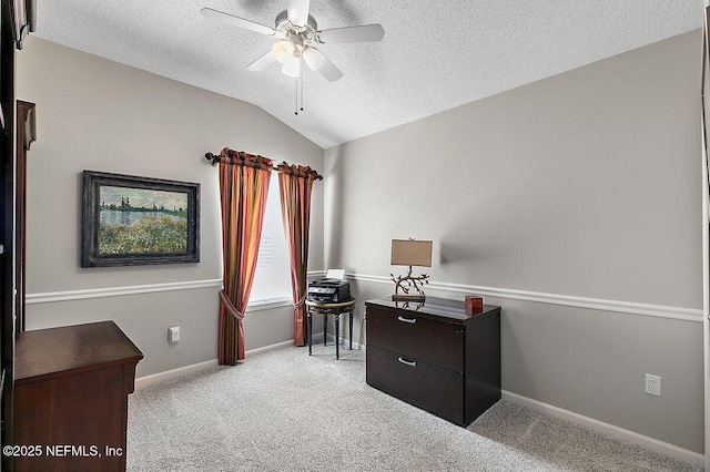 interior space featuring lofted ceiling, a textured ceiling, light colored carpet, and ceiling fan