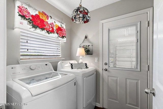 clothes washing area with washing machine and clothes dryer