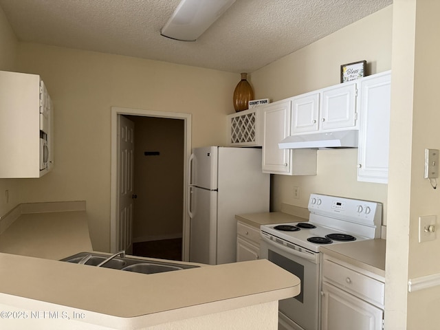 kitchen featuring sink, white appliances, a textured ceiling, white cabinets, and kitchen peninsula