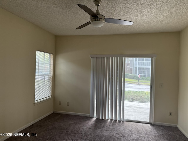 empty room with a textured ceiling, ceiling fan, and carpet