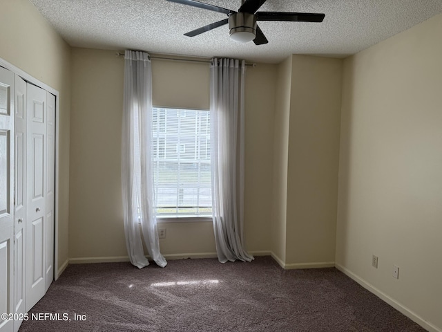 unfurnished bedroom featuring ceiling fan, a closet, carpet, and a textured ceiling