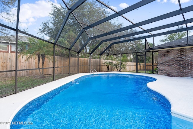 view of pool with a patio and a lanai