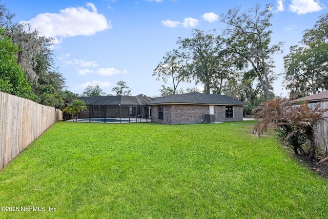 view of yard featuring a fenced in pool and a lanai