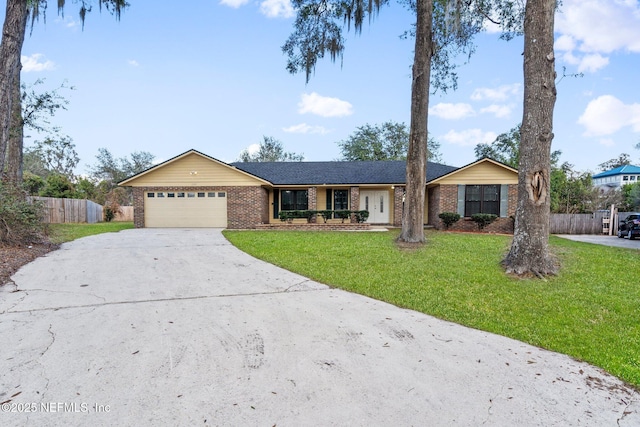 ranch-style home featuring a garage and a front lawn