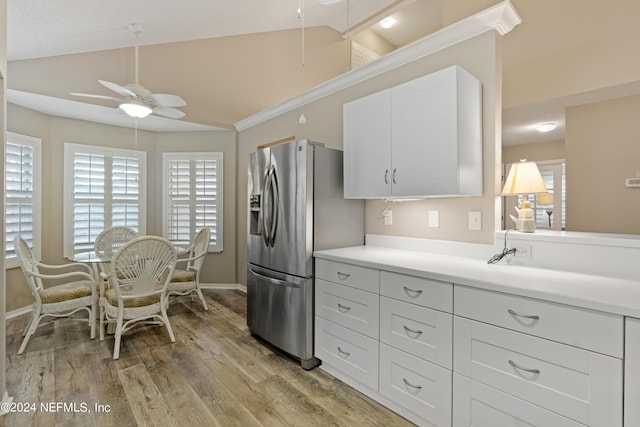 kitchen featuring stainless steel refrigerator with ice dispenser, lofted ceiling, white cabinetry, ceiling fan, and light hardwood / wood-style floors