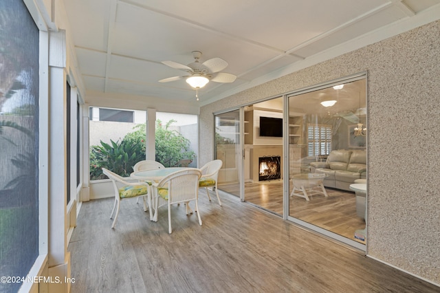 unfurnished sunroom with ceiling fan