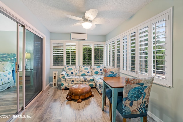 sunroom / solarium with ceiling fan and a wall unit AC