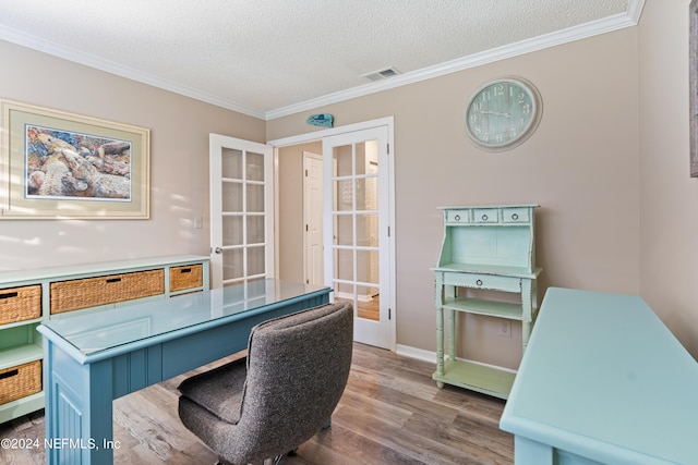 office featuring hardwood / wood-style flooring, ornamental molding, a textured ceiling, and french doors