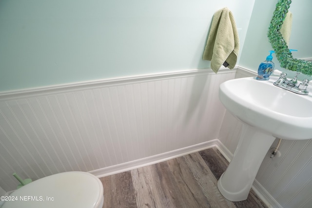 bathroom with wood-type flooring and toilet